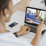 Black lady working on a laptop in her office